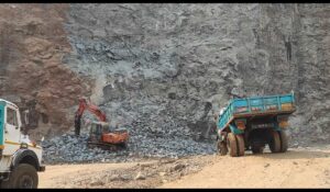 Excavator and trucks engaged in minor mineral excavation at a quarry site in Maharashtra amid the government’s crackdown on illegal mining activities.