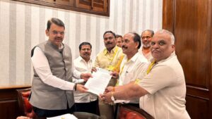 Maharashtra Chief Minister Devendra Fadnavis receiving memorandum from Municipal Mazdoor Union representatives regarding housing scheme for sanitation workers in Mumbai