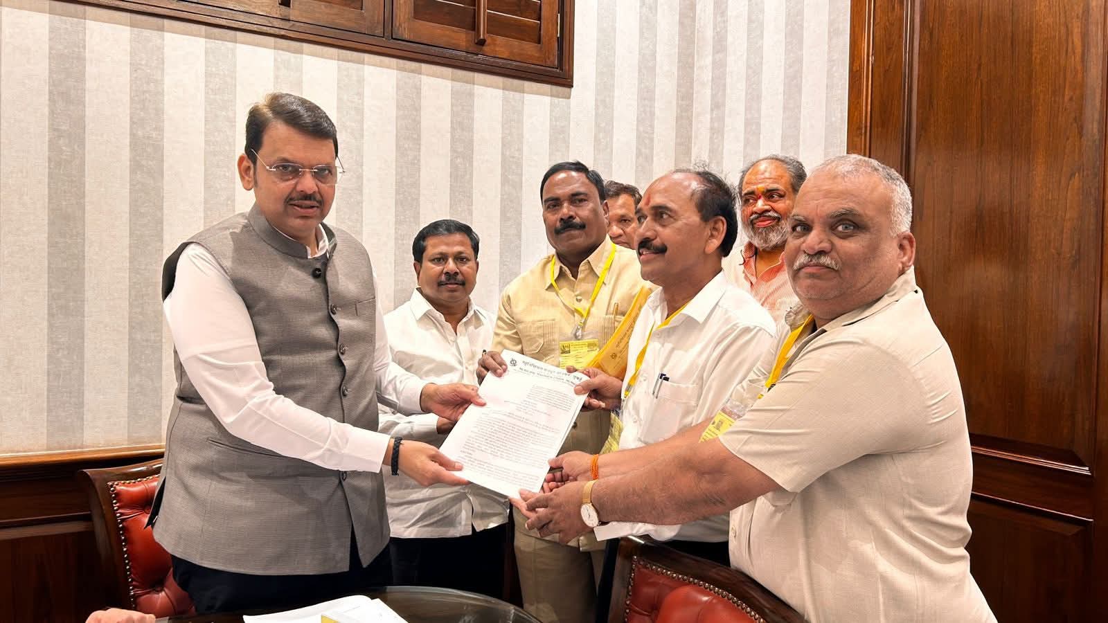 Maharashtra Chief Minister Devendra Fadnavis receiving memorandum from Municipal Mazdoor Union representatives regarding housing scheme for sanitation workers in Mumbai