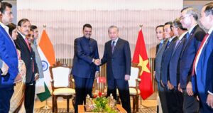 Maharashtra Chief Minister Devendra Fadnavis shakes hands with Vietnam President Tô Lâm during the India-Vietnam Business Forum in Mumbai