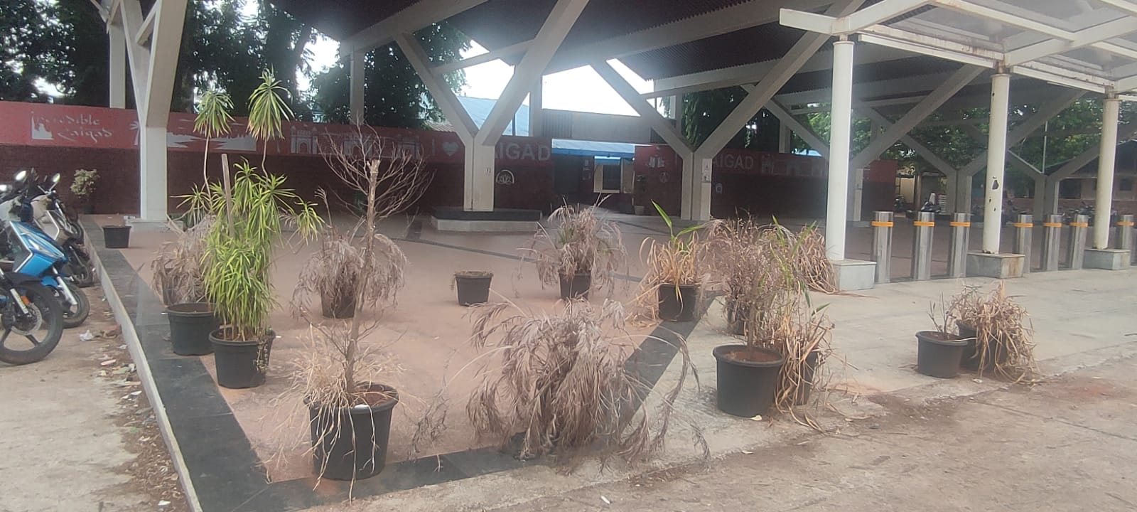 Entrance view of Veer railway station near Mahad showing neglected beautification work and dried plants