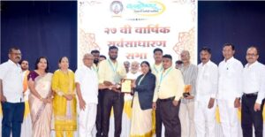 Ballaleshwar Cooperative Credit Society 27th Annual General Meeting Navi Mumbai, member felicitation ceremony and board members on stage.
