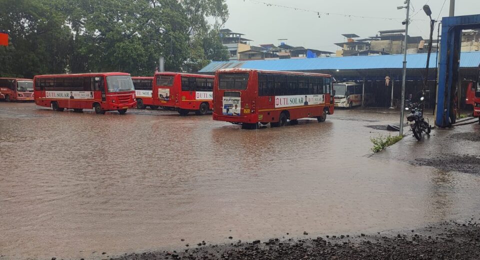 Multiple Maharashtra State Transport (ST) buses parked in floodwater at Mahad Bus Stand after heavy monsoon rain in Raigad district.